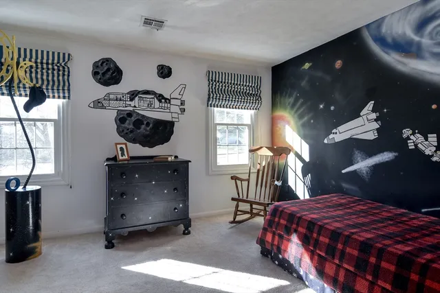 a bedroom with a bed and a chandelier