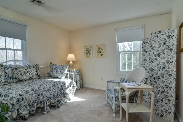 a bedroom with bed and a window