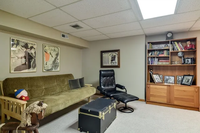a living room with furniture a book shelf and a book shelf