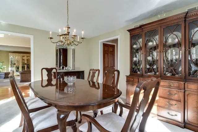 a view of a dining room with furniture and a chandelier