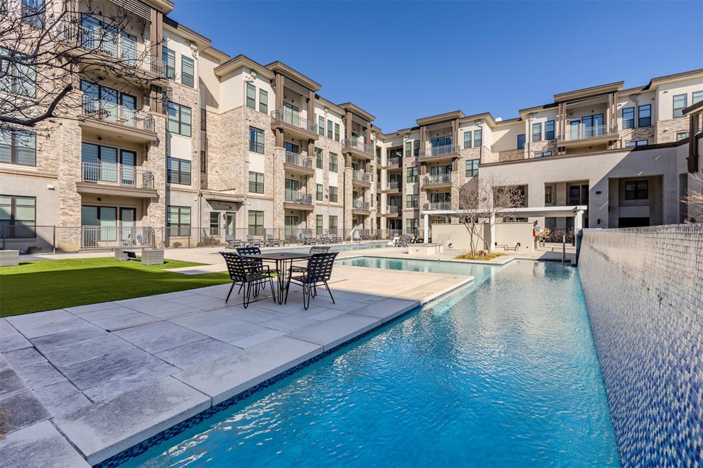 2700 Old Denton Road, Unit 1044 Carrollton, TX 75007 - Photo 31 of 33 Central courtyard featuring a swimming pool, adjacent hardscaping, and a synthetic turf lawn