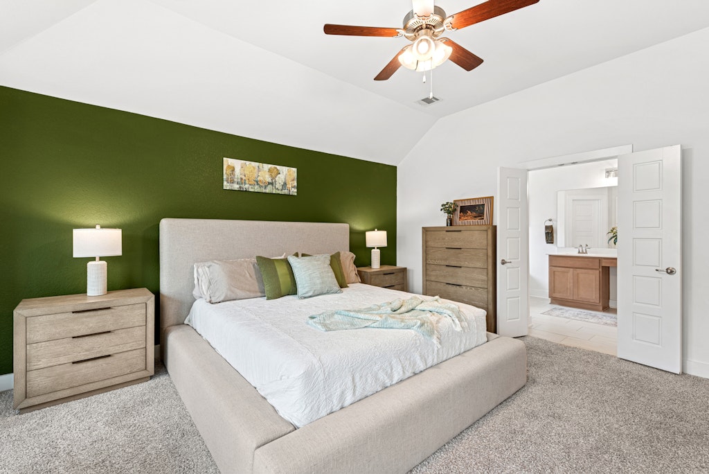 113 Wake Lane Georgetown, TX 78633 - Photo 12 of 33 a bedroom with a bed and a chandelier