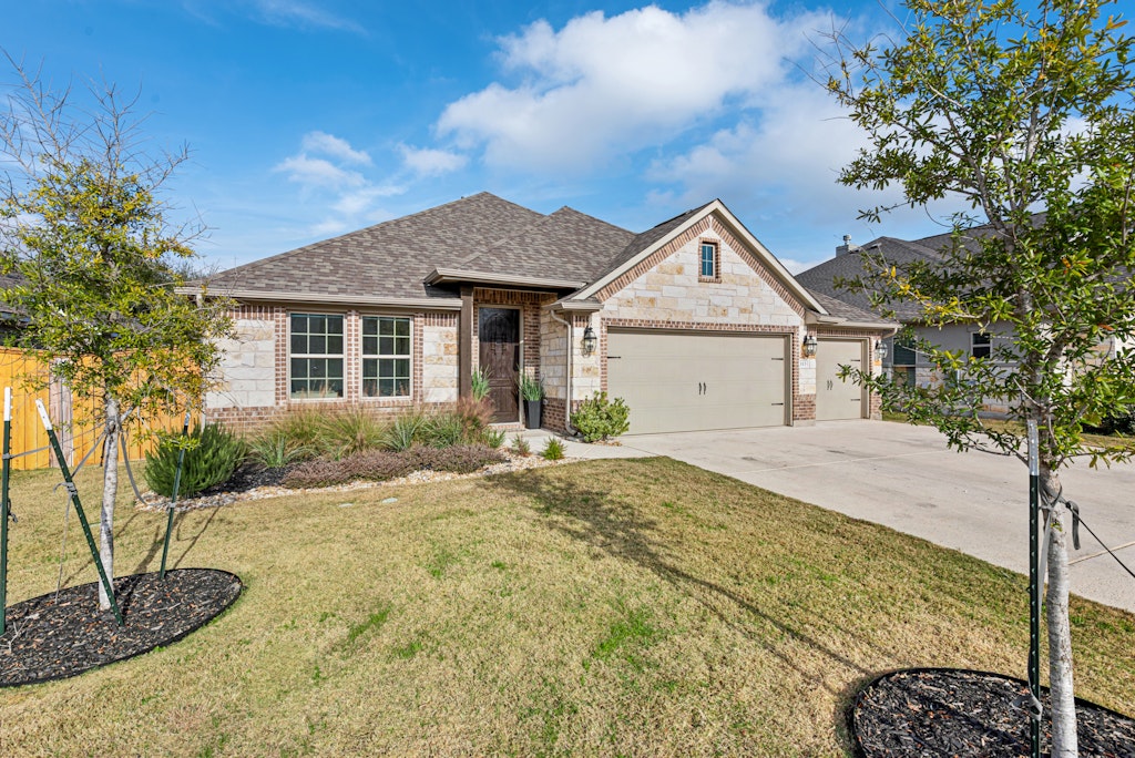 113 Wake Lane Georgetown, TX 78633 - Photo 2 of 33 a house view with a garden space