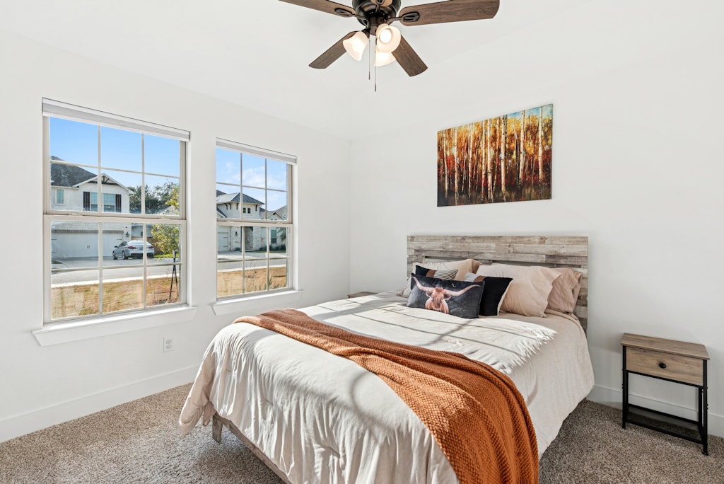 113 Wake Lane Georgetown, TX 78633 - Photo 19 of 33 a bedroom with a bed and a window