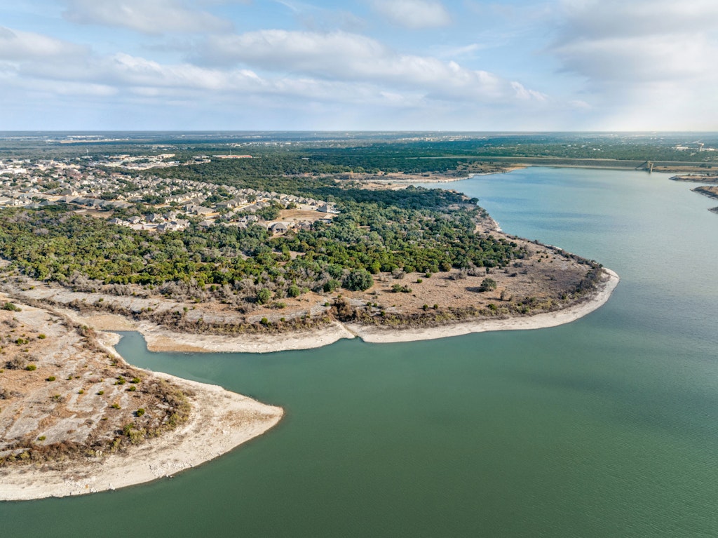 113 Wake Lane Georgetown, TX 78633 - Photo 28 of 33 a view of a lake with a mountain