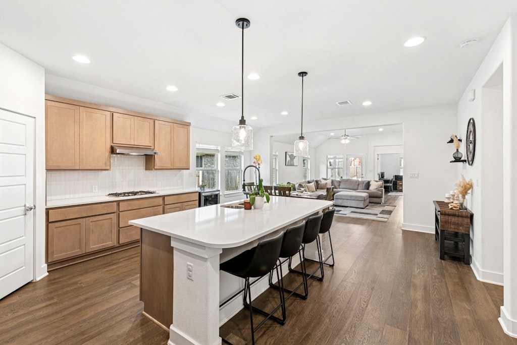113 Wake Lane Georgetown, TX 78633 - Photo 5 of 33 a large kitchen with kitchen island a island a sink a counter space and stainless steel appliances