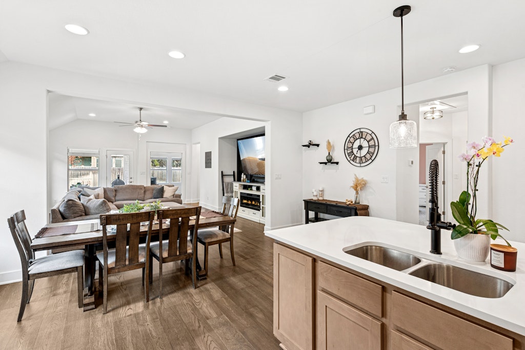 113 Wake Lane Georgetown, TX 78633 - Photo 8 of 33 a kitchen with a table chairs sink and cabinets