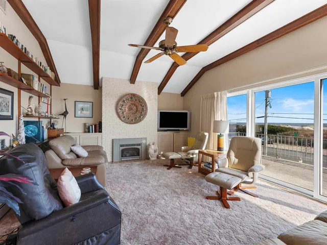 a living room with furniture a window and a clock