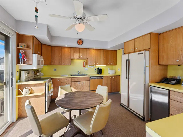 a kitchen with a table chairs sink and cabinets