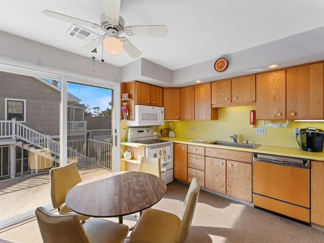 a kitchen with stainless steel appliances a stove a sink and cabinets