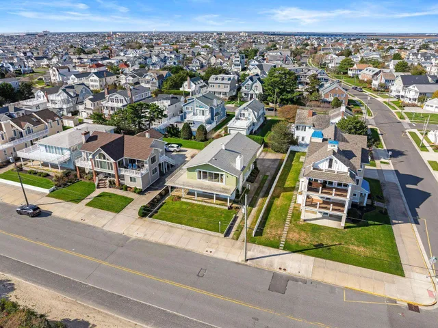 an aerial view of a house with a big yard and potted plants