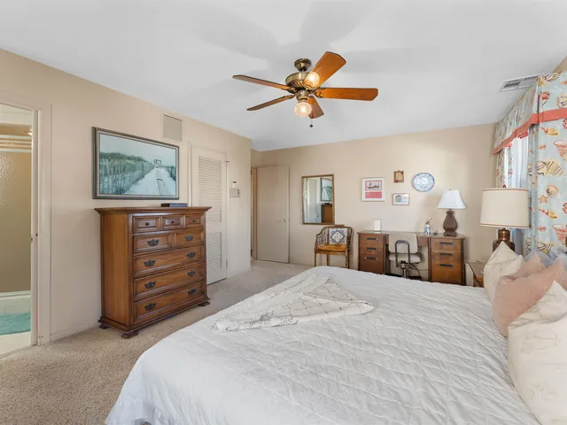 a spacious bathroom with a double vanity sink toilet mirror and bathtub