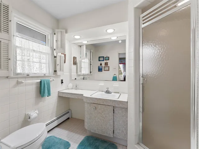 a bedroom with a bed and dresser