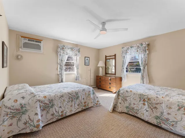 a bedroom with a large bed and wooden floor