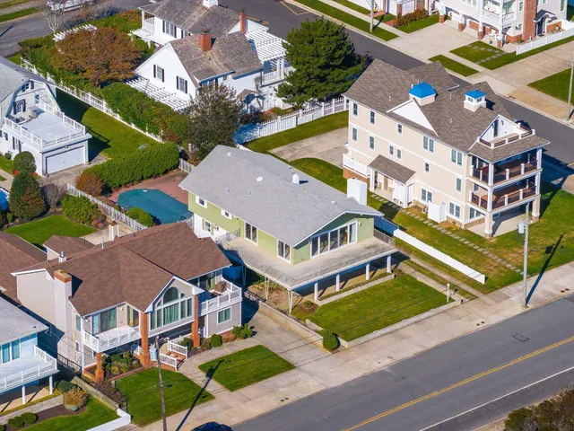 an aerial view of multiple houses with a yard
