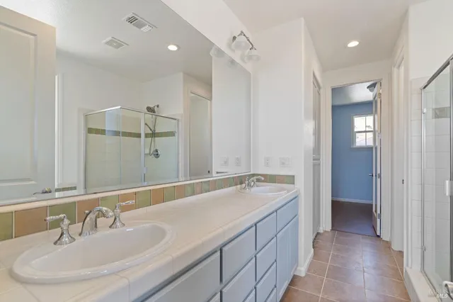 a bathroom with a sink double vanity and a mirror