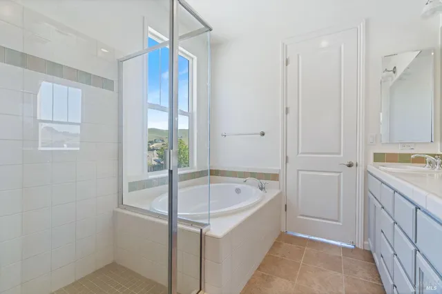 a bathroom with a tub shower and sink