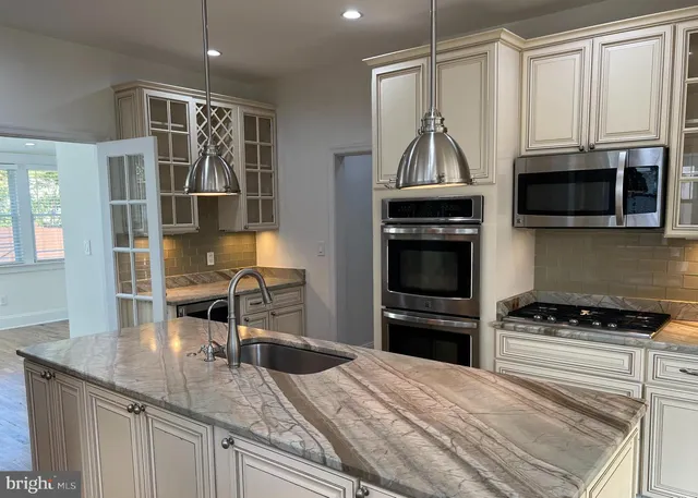 a kitchen with granite countertop a stove and a sink