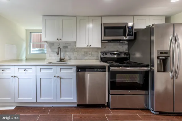 a view of a room with wooden floor and window