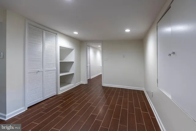a view of a room with wooden floor and window