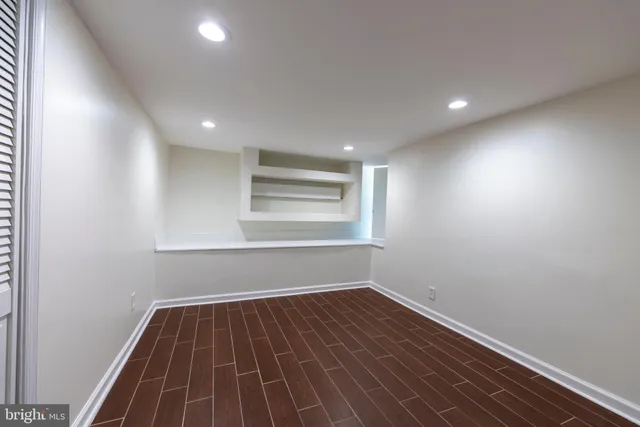a room with wooden floor and closet