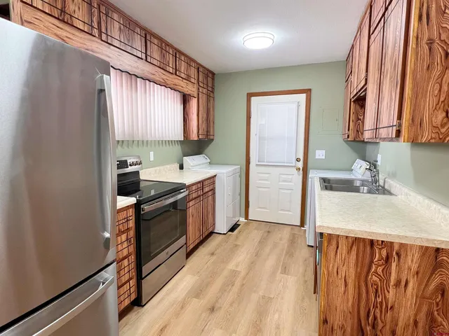 a kitchen with a stove a sink and a refrigerator