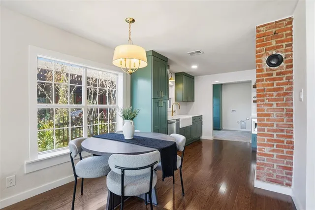 a view of a dining room with furniture wooden floor and chandelier