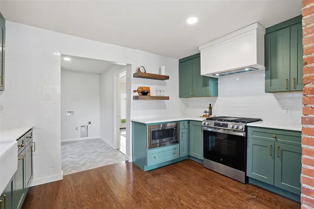 a kitchen with stainless steel appliances granite countertop a stove and a sink
