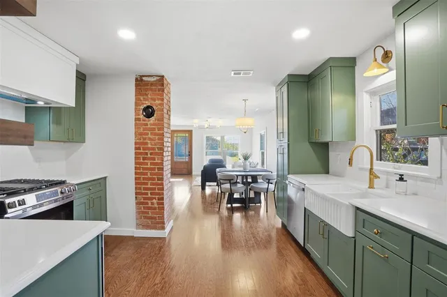 a kitchen with counter top space a sink appliances and cabinets