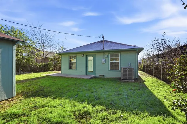 a house with green field in front of it