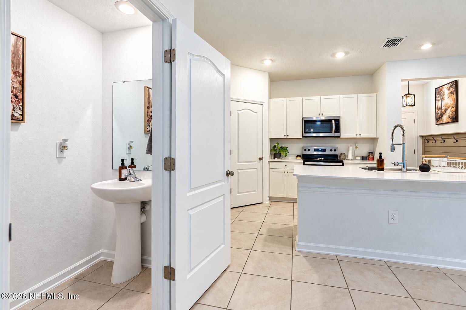 175 Seaport Breeze Road St. Augustine, FL 32095 - Photo 11 of 23 half bath and kitchen