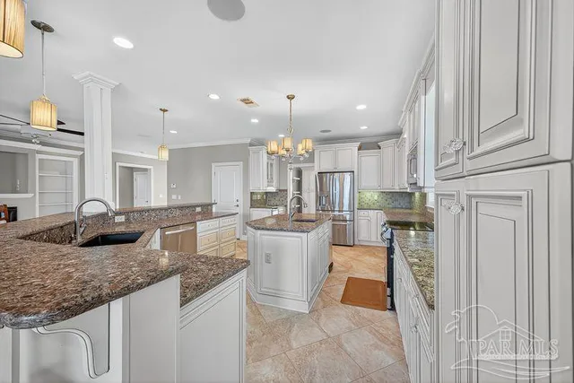 a view of an empty room with a window and chandelier