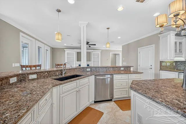 a view of an empty room with a window and chandelier