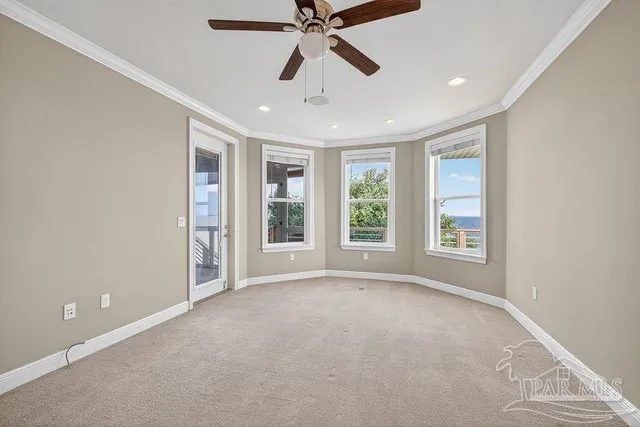 a view of an empty room with a white walls and a window