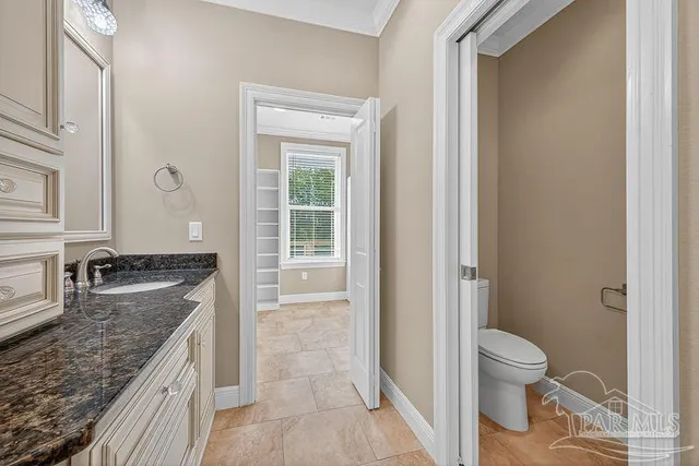 a kitchen with granite countertop a sink and cabinets
