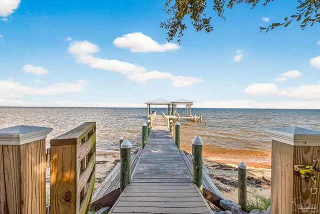 a view of a balcony with wooden floor and outdoor space