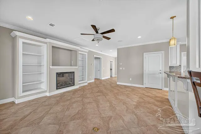 a large white kitchen with stainless steel appliances cabinets a sink and a counter top space