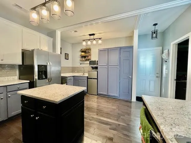 a kitchen with a refrigerator a sink and a oven