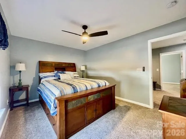 a bedroom with a bed and large windows