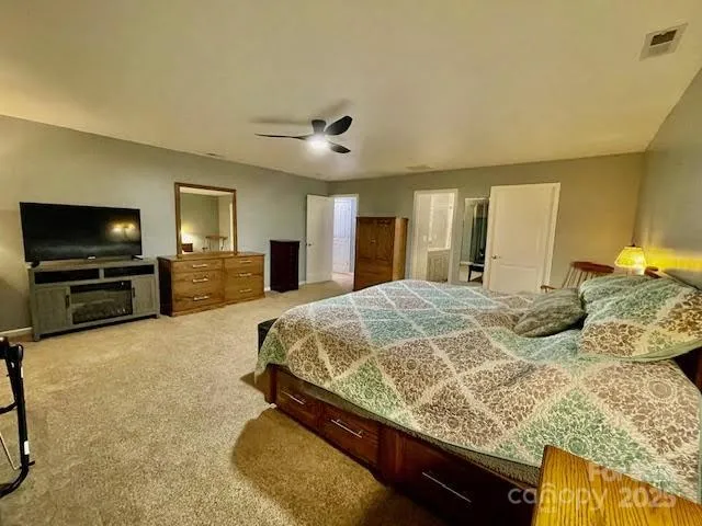 a bed room with a bed and a television in it