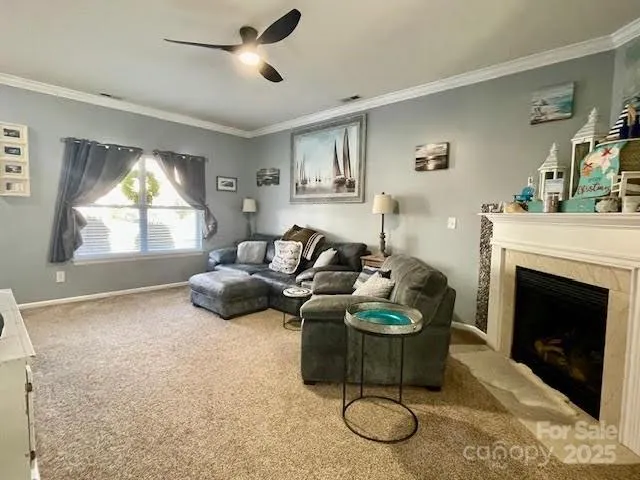 a living room with furniture a fireplace and a large window