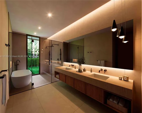 a bathroom with a double vanity sink a mirror and a bathtub