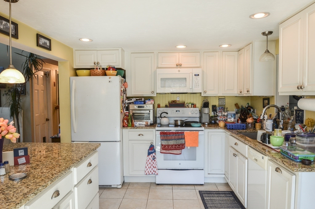 60 Marlboro Road Berlin, MA 01503 - Photo 11 of 34 a kitchen with stainless steel appliances granite countertop a refrigerator sink stove and white cabinets