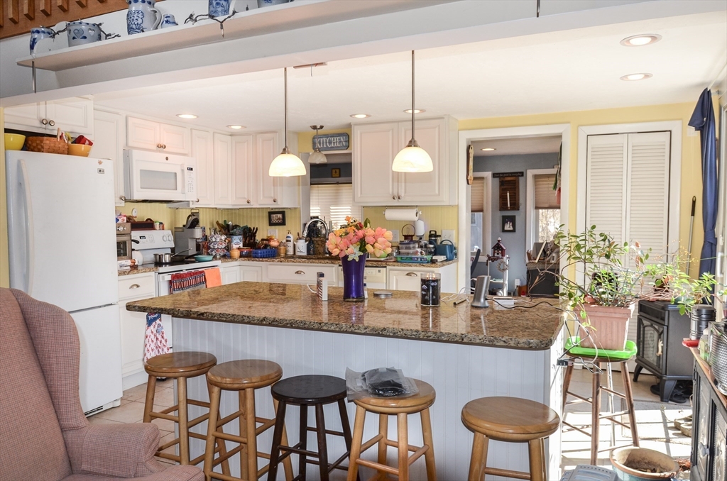 60 Marlboro Road Berlin, MA 01503 - Photo 12 of 34 a kitchen with stainless steel appliances granite countertop a table chairs and a refrigerator