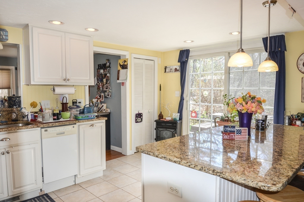 60 Marlboro Road Berlin, MA 01503 - Photo 13 of 34 a kitchen with stainless steel appliances granite countertop a refrigerator a sink and white cabinets