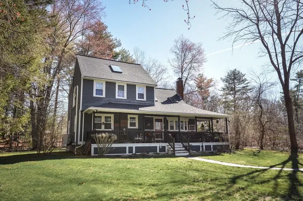 a front view of a house with a yard table and chairs