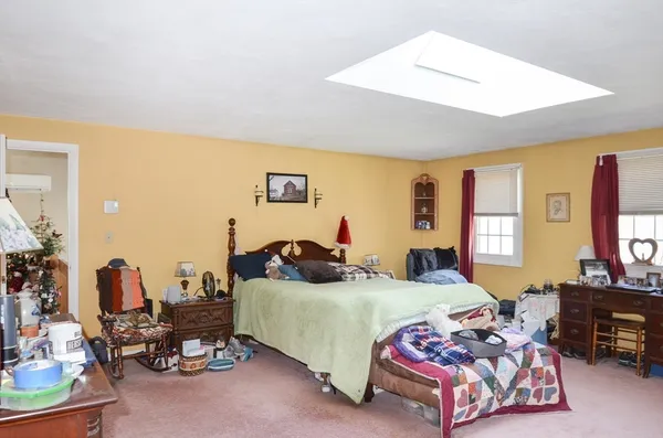 a bedroom with furniture and a flat screen tv