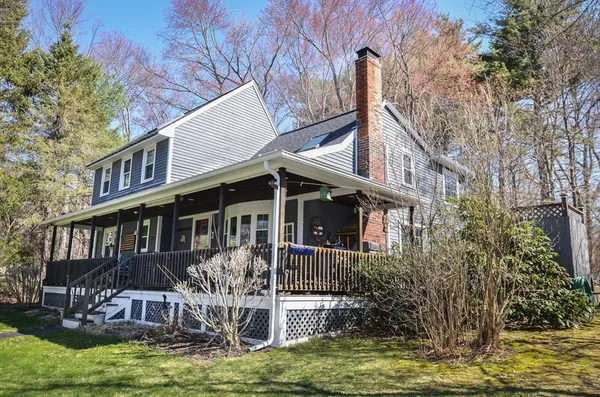 a front view of a house with balcony and garden