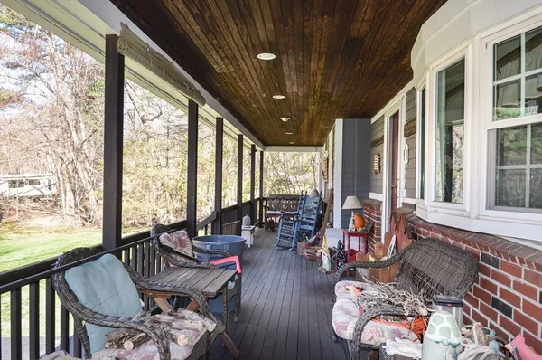 a living room with furniture and floor to ceiling windows