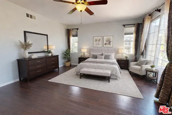 a bedroom with a bed window and a dresser